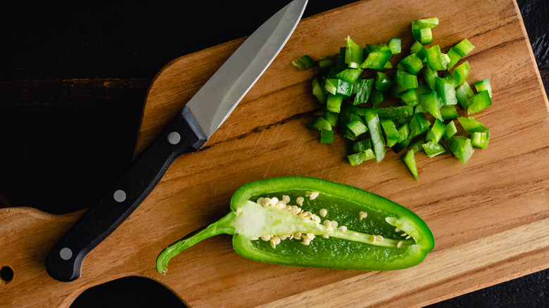 Sliced jalape&ntilde;os on cutting board